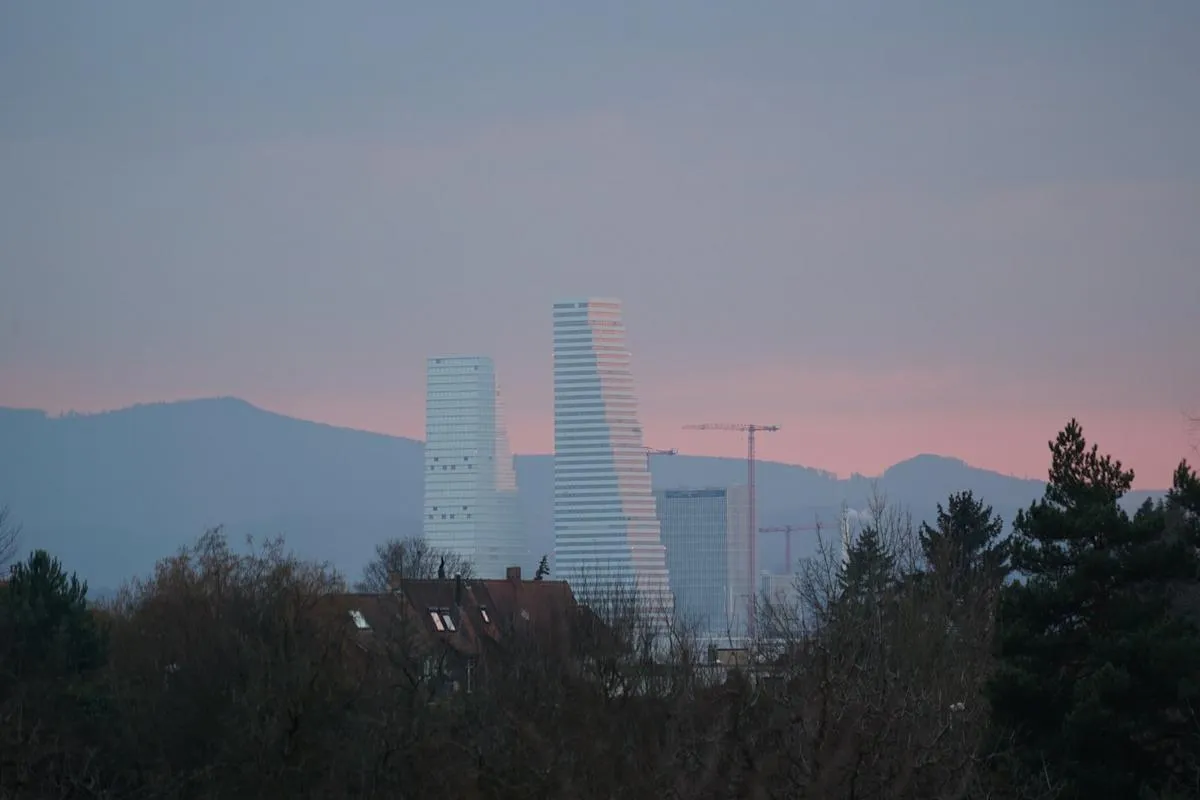 Cooling towers of a power plant emitting steam against a dusk sky, symbolizing industrial energy infrastructure.