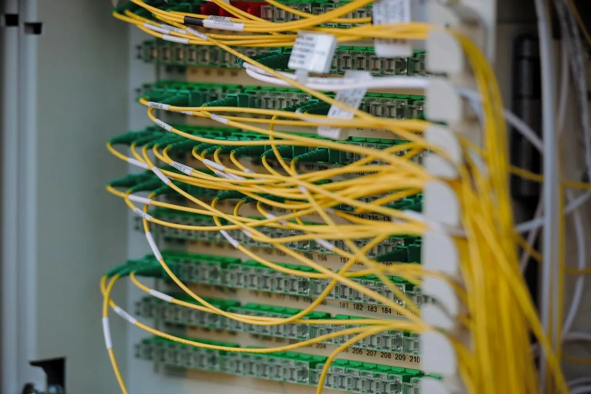 Illuminated server racks in a data center with glowing blue lights.