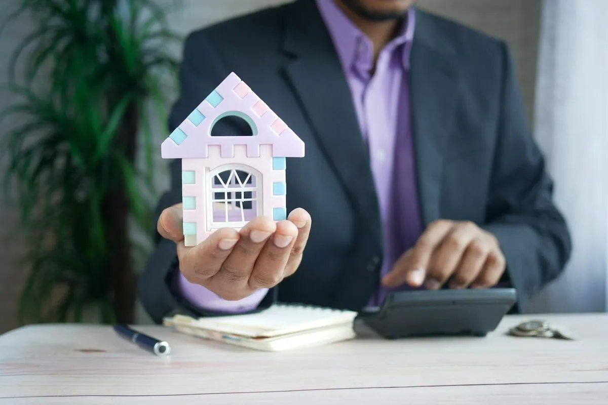 A homeowner reviewing property tax and insurance documents on a wooden desk