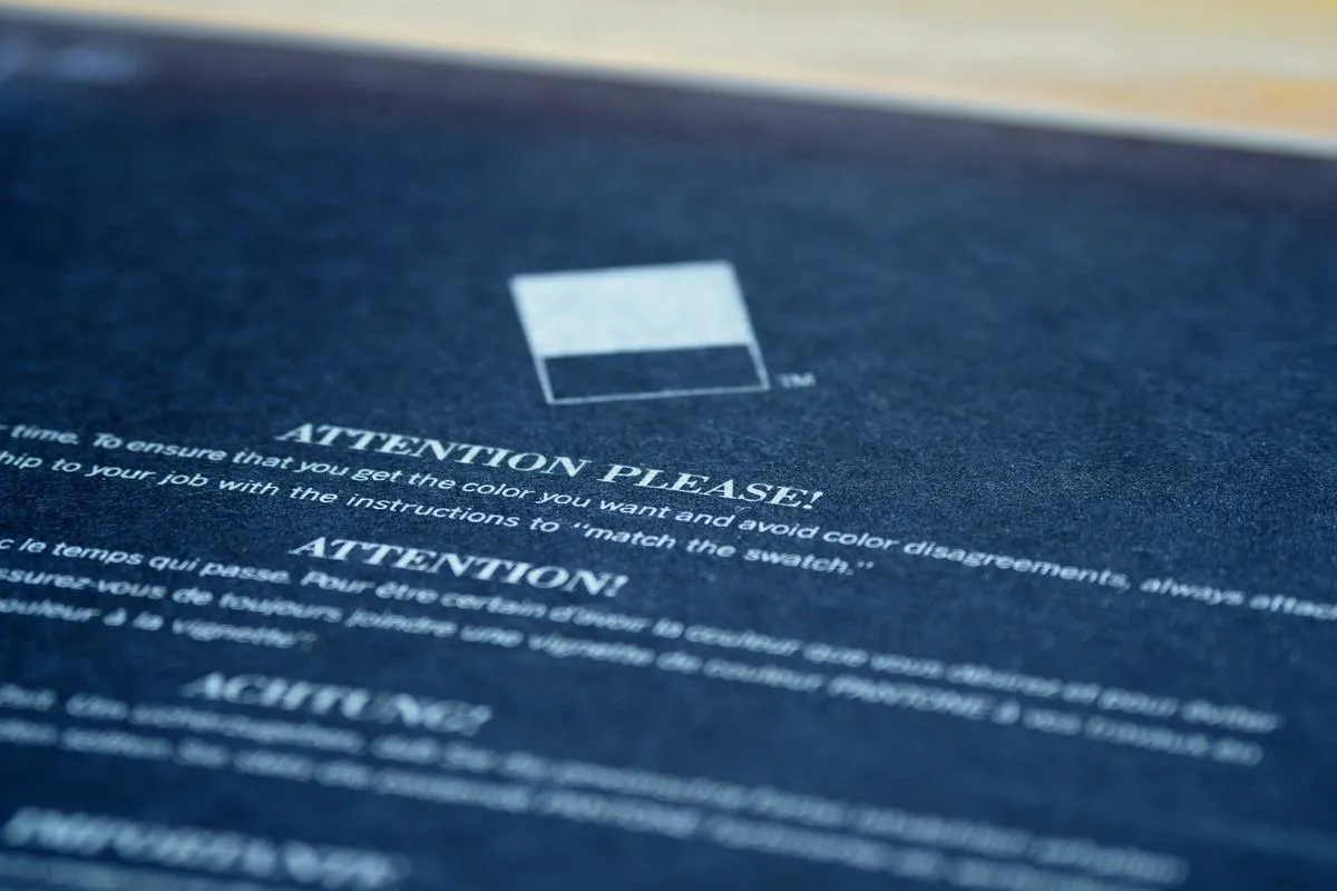 A close-up of a maintenance assessment notice for a condo building with a blurred background of high-rise condos.