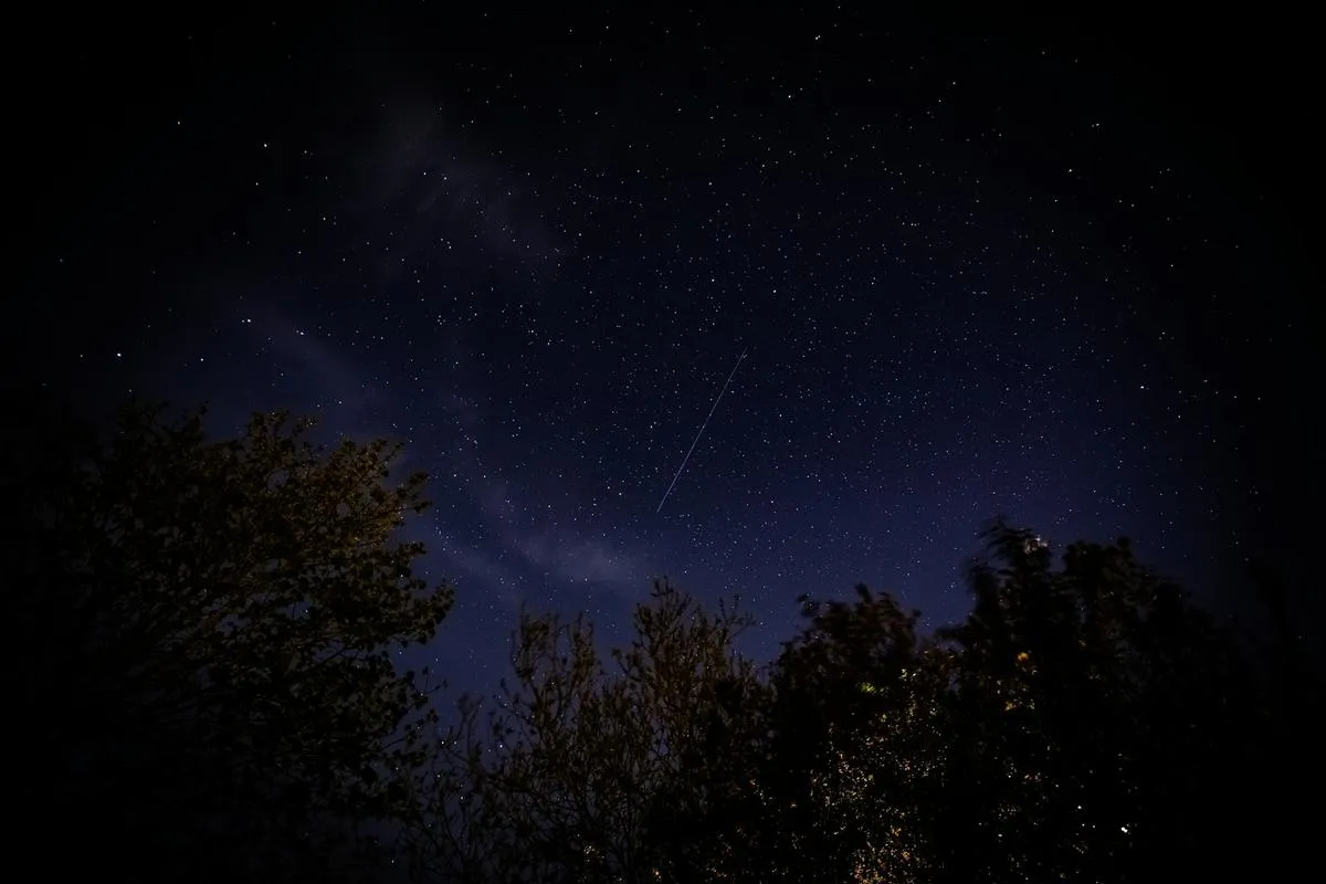 Starlink satellite dish under starry sky
